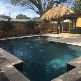 a pool with a thatched roof a pool with a thatched roof