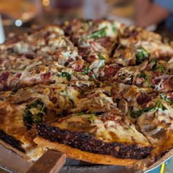 Satchel's Pizza - The specialty pizza topped with meatballs, spinach, and bacon.