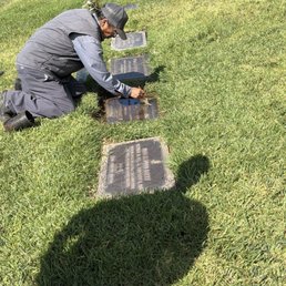 Pedro cleaning the headstone Pedro cleaning the headstone