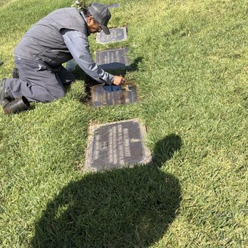 Forest Lawn - Covina Hills - Pedro cleaning the headstone - Mortuary Services Near Me - Covina, California Forest Lawn - Covina Hills - Pedro cleaning the headstone - Mortuary Services Near Me - Covina, California