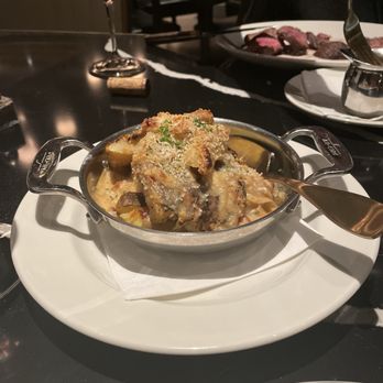 Rudy's Prime Steakhouse - Tarteflette (potatoes with carmelized onions, bacon, and Gruyère cheese - Steakhouses Near Me - Clarkston, Michigan Rudy's Prime Steakhouse - Tarteflette (potatoes with carmelized onions, bacon, and Gruyère cheese - Steakhouses Near Me - Clarkston, Michigan