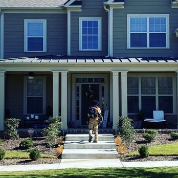 Grass King Lawn Services - a man walking into a house - Lawn Services Near Me Grass King Lawn Services - a man walking into a house - Lawn Services Near Me