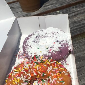 Duck Donuts - Original glaze w/ rainbow sprinkles and blueberry glaze w/ powdered sugar. - Donuts Near Me - Duck, North Carolina Duck Donuts - Original glaze w/ rainbow sprinkles and blueberry glaze w/ powdered sugar. - Donuts Near Me - Duck, North Carolina