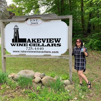 Lakeview Wine Cellars - a woman standing in front of a sign - Wineries Near Me - North East, Pennsylvania