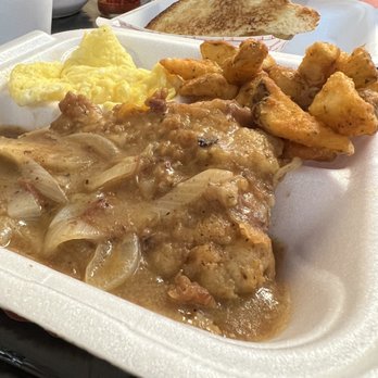 Nikki's Place - Smothered pork chops, home fries, and scrambled eggs - Southern Near Me - Orlando, Florida