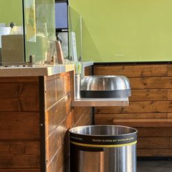 They cleaned the trash and left the trash lid on the counter where the drinks are put