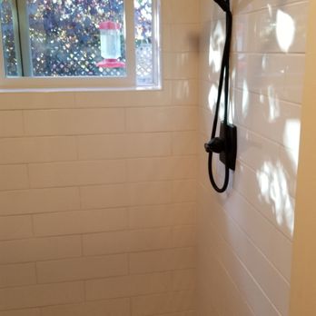 Rodrigo Valencia Tile - a shower with a shower head - Flooring Near Me Rodrigo Valencia Tile - a shower with a shower head - Flooring Near Me