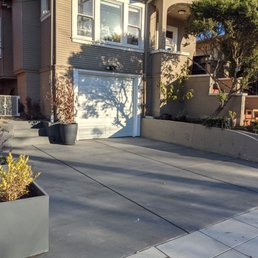 Repaved driveway with new (straight) garage door.