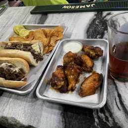 Cheesesteak and wings. Cheesesteak and wings.