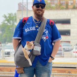 a man with a dog in a carrier