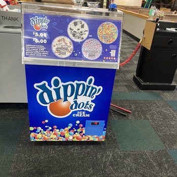 Chuck E. Cheese - A Dippin Dots ice cream vending machine is positioned inside Chuck E. Cheese in Skokie, Illinois, featuring colorful branding and a display of various ice cream flavors. - Pizza Near Me - Skokie, Illinois