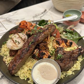 Ayat NYC - Mixed grill with lamb, beef, and chicken over a bread of warm soft rice - Arabic Near Me - Brooklyn, New York Ayat NYC - Mixed grill with lamb, beef, and chicken over a bread of warm soft rice - Arabic Near Me - Brooklyn, New York