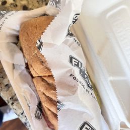 a sandwich wrapped in paper a sandwich wrapped in paper