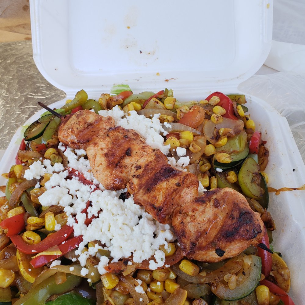 Sauteed mixed veggies on top of lettuce with chicken kabob Sauteed mixed veggies on top of lettuce with chicken kabob