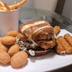 Zo's Good Burger Livonia - The Good burger with Swiss cheese, onion rings, and pickles, and accompanied by fries, large mac and cheese bites, and decadent mozz sticks.