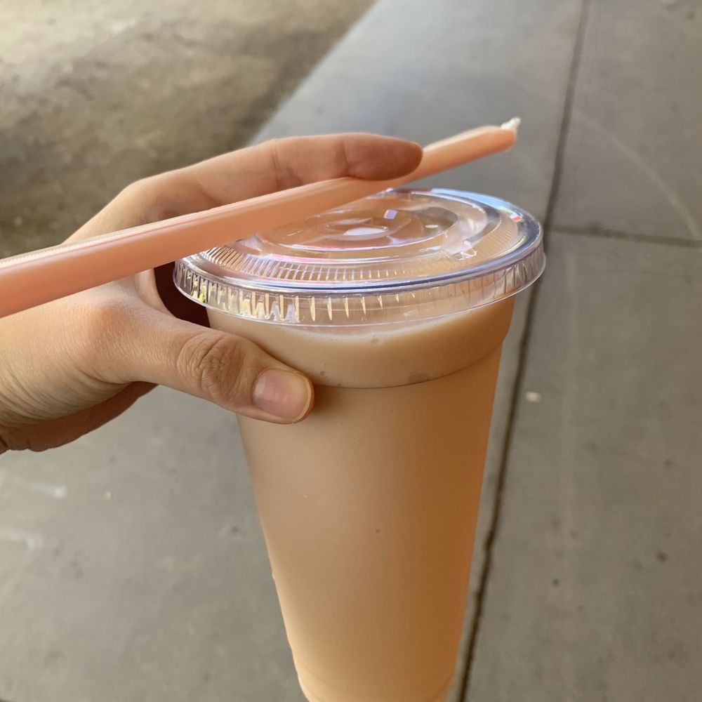 a hand holding a plastic cup of jamba juice a hand holding a plastic cup of jamba juice