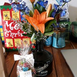 Beer growler flower arrangement, candy, and coupons