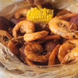 Shrimp boil, headless and with heads, potatoes, sausages and corn, spicy.