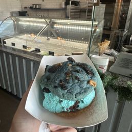 Ice cream sandwich w/ lactaid in hand Ice cream sandwich w/ lactaid in hand