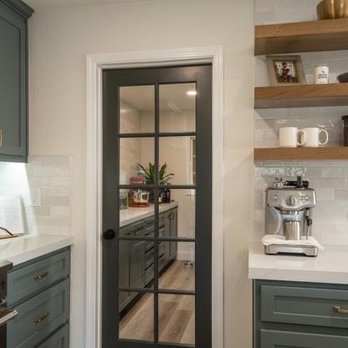 kitchen & bath CRATE - Butler pantry - A kitchen featuring blue-gray cabinets, open wooden shelves, and a black-framed glass door to an adjacent room. - General Contractors Near Me - Salida, California