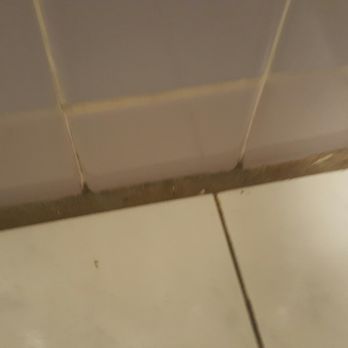 The Tiki - Tile in bathroom, very dirty. Rust on fixtures. I had to wear my shoes in here. - Resorts Near Me - Lake George, New York
