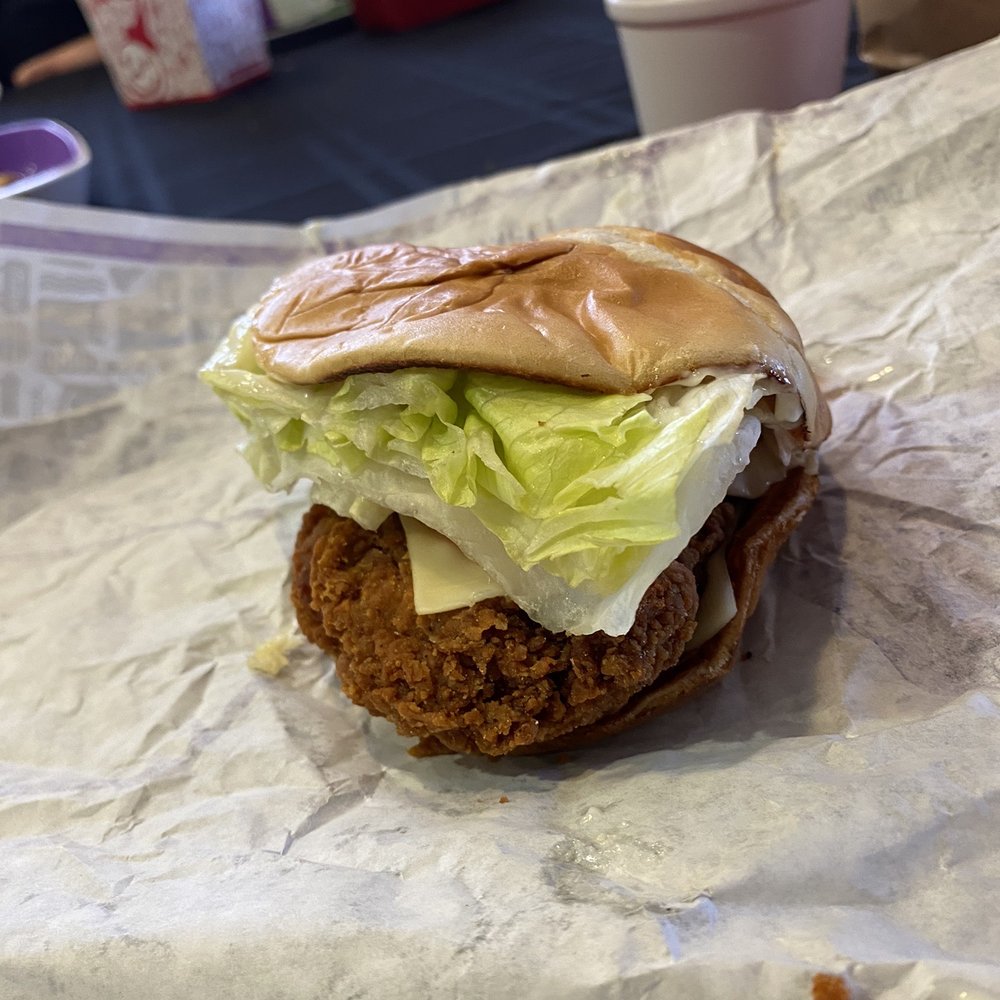 Spicy chicken sandwich smashed completely flattening the bread. Spicy chicken sandwich smashed completely flattening the bread.