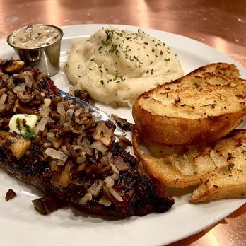 Cask Strength Bar and Kitchen - New York steak with sautéed mushrooms and onions, fluffy garlic mashed potatoes, and house made garlic Parmesan toast. - Cocktail Bars Near Me - Bakersfield, California