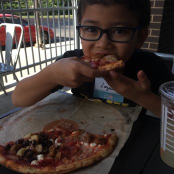 Blaze Pizza - Enjoying pizza from his favorite pizza chain.  Only Blaze offers roasted garlic. - Salad Near Me - Ames, Iowa
