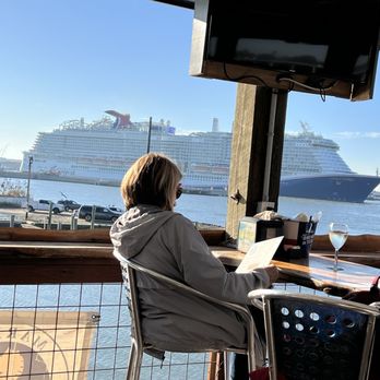 Marina Bar & Grill - View of cruise ship leaving port 4ish PM. 2/1/2025. - American Near Me - Galveston, Texas