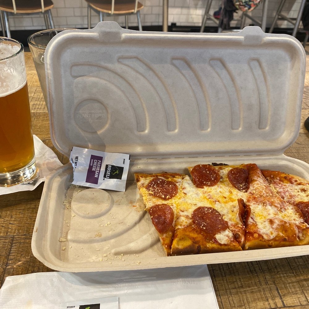 a slice of pepperoni pizza in a styrofoam container a slice of pepperoni pizza in a styrofoam container