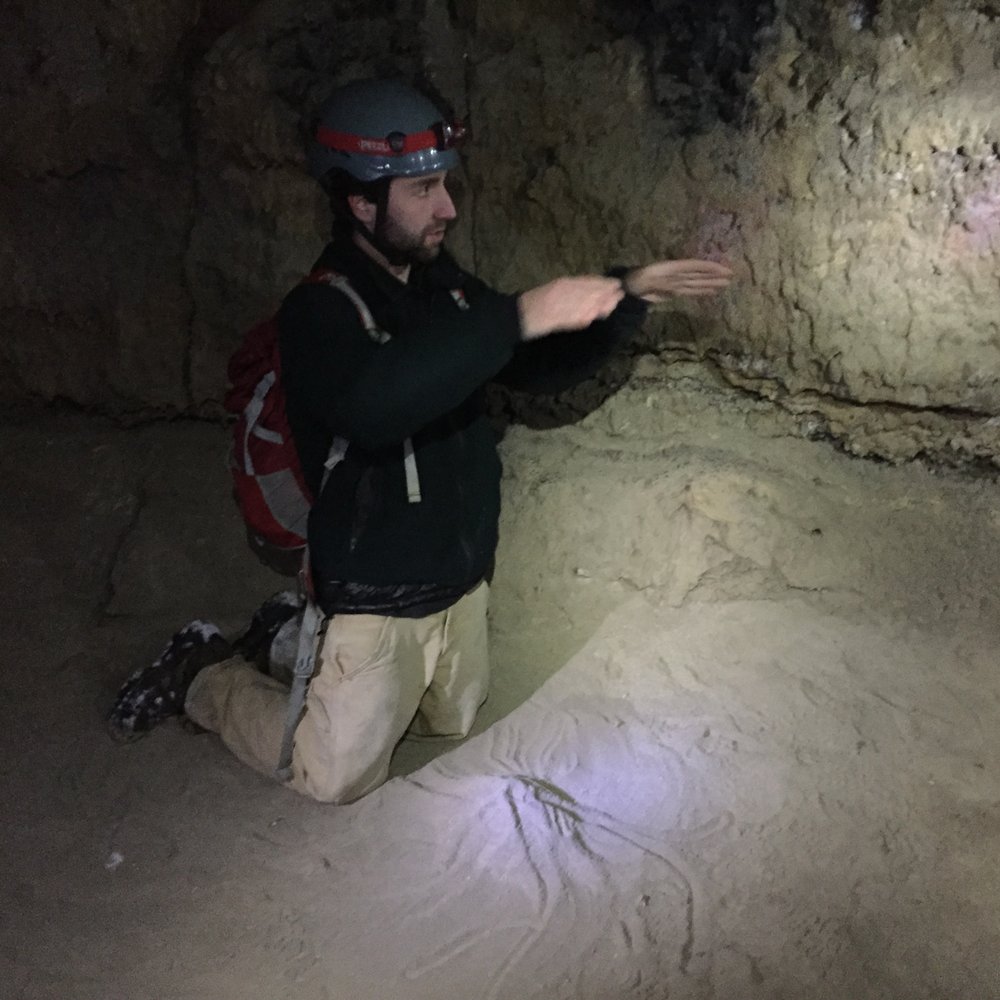 Wanderlust Tours - Tour leader Jared explains and demonstrates lava tube creation inside the Boyd cave tour. - Tours Near Me - Bend, Oregon Wanderlust Tours - Tour leader Jared explains and demonstrates lava tube creation inside the Boyd cave tour. - Tours Near Me - Bend, Oregon