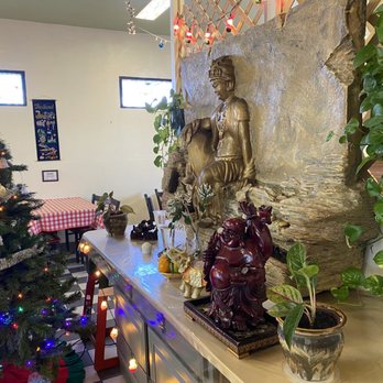 Namtip Thai Cuisine - a christmas tree and buddha statue - Thai Near Me - Daytona Beach, Florida Namtip Thai Cuisine - a christmas tree and buddha statue - Thai Near Me - Daytona Beach, Florida