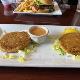 This is exactly how it was delivered to the table. Doesn't even look like crab cakes. Sad squashed patties with a pittance of lettuce. This is exactly how it was delivered to the table. Doesn't even look like crab cakes. Sad squashed patties with a pittance of lettuce.