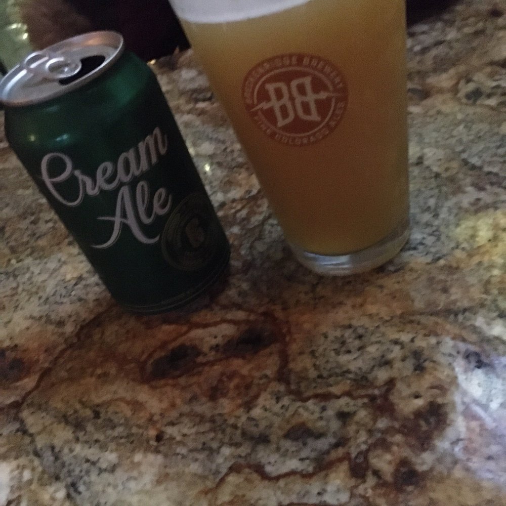 Dive 75 - a beer and a can on a table - Dive Bars Near Me - New York, New York