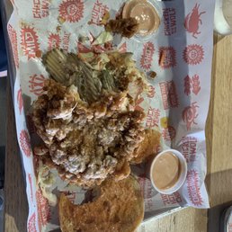 Giant pile of greasy breading atop a grease soaked bun. Giant pile of greasy breading atop a grease soaked bun.