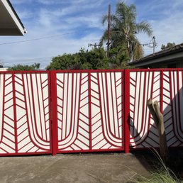 Custom metal fence and gate with deadbolt and knob for security. Red powder coating with a white powder metal backing.