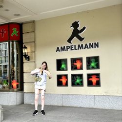 AMPELMANN - A fan having her picture taken in front of der Ampelmann store sign.