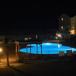 Night shot of pool. Lights come on at 8:08!