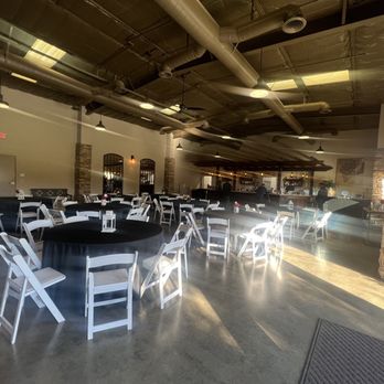 San Joaquin Winery - View of seating area inside tasting room. Tasting area in background. Room set up for a private party with overflow area in the back - Wineries Near Me - Madera, California