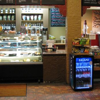 Espresso Royale Krannert View - This is a view of the barista counter and the glass display case, complete with a small fridge for Dasani water for muggy days you'd need it - Coffee & Tea Near Me - Urbana, Illinois Espresso Royale Krannert View - This is a view of the barista counter and the glass display case, complete with a small fridge for Dasani water for muggy days you'd need it - Coffee & Tea Near Me - Urbana, Illinois