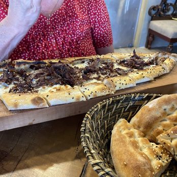 Chef’s Table - That is the beef doner pide on top and the bread basket. - Mediterranean Near Me - San Antonio, Texas