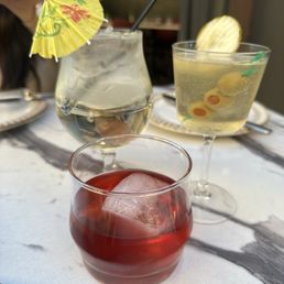 From front to back L to R: spritz, dirty pickle martini, blueberry Negroni From front to back L to R: spritz, dirty pickle martini, blueberry Negroni