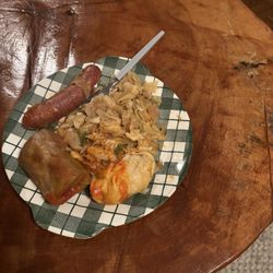 Al's Corner Restaurant - Sampler platter with a mild sausage smothered in cooked onions and peppers, a cabbage roll, and a pierogi.