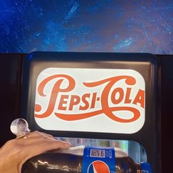 Pepsi machine inside store.