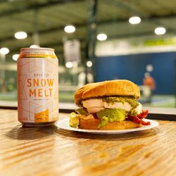 3rd Shot Pickleball - A Vegetarian mozzarella pesto sandwich accompanied by a Snow Melt hard seltzer.