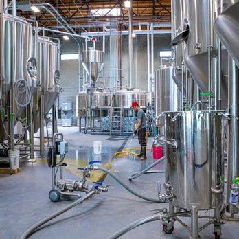 Eppig Brewing - The head brewer hard at work. The brewery is visible through large windows in the tasting room. - Breweries Near Me - Vista, California
