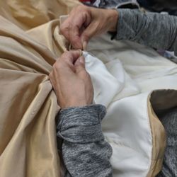 Stitch - One of our seamstress doing an emergency zipper repair on a wedding gown.