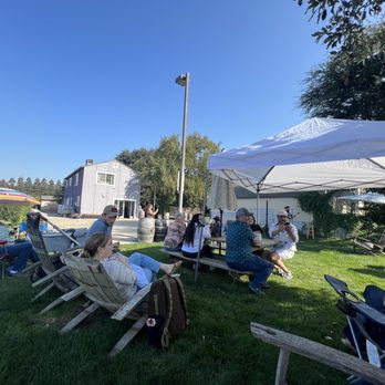 Pondl Winery - a group of people sitting in lawn chairs - Wineries Near Me - Lodi, California