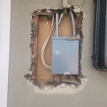 The Stucco Shop - Before repair hole left by electrician after an electrical panel upgrade. - Stucco Services Near Me The Stucco Shop - Before repair hole left by electrician after an electrical panel upgrade. - Stucco Services Near Me