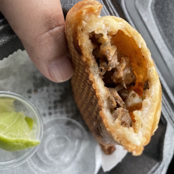 Panguich - a hand holding a sandwich with meat and vegetables - Sandwiches Near Me - Cooper City, Florida
